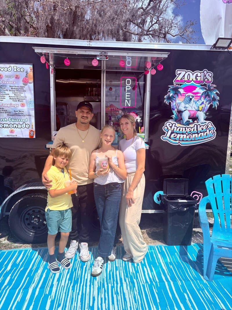 Matthew Schmidt and Danielle Hansen with family in front of Zogi's Shaved Ice & Lemonade food truck