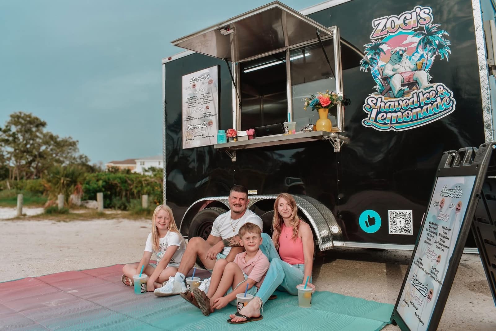Family enjoying Zogi's Shaved Ice & Lemonade at the trailer