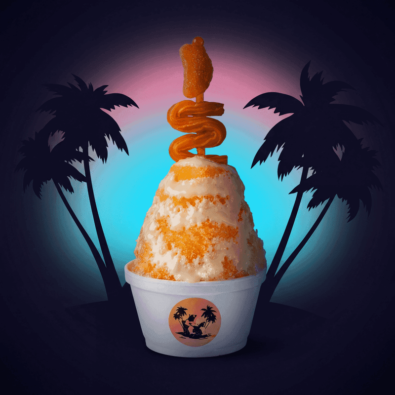 Orange Dreamsicle from Zogi's Shaved Ice & Lemonade — Creamy orange-and-white swirl with gummy candy stack — a 70s ice cream truck classic